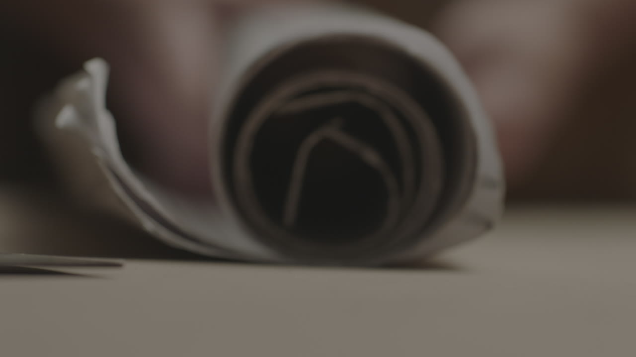 persona desenrollando planos en estrecha profundidad de campo.