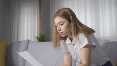 Traurige,-Am-Boden-Zerstörte-Junge-Frau,-Die-Auf-Papier-Schaut.