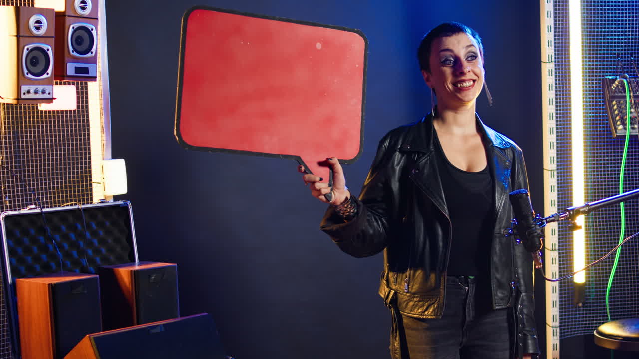 Woman Holding Speech Bubble in Music Studio