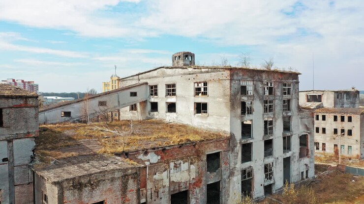 Aerial view of an old factory ruin and broken windows. Old industrial building for demolition.