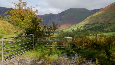 tracking shot past a gate to mountains in north wales in the uk