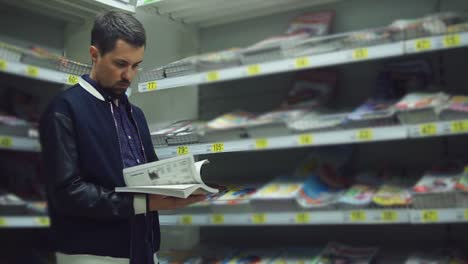 man browsing magazines in a store