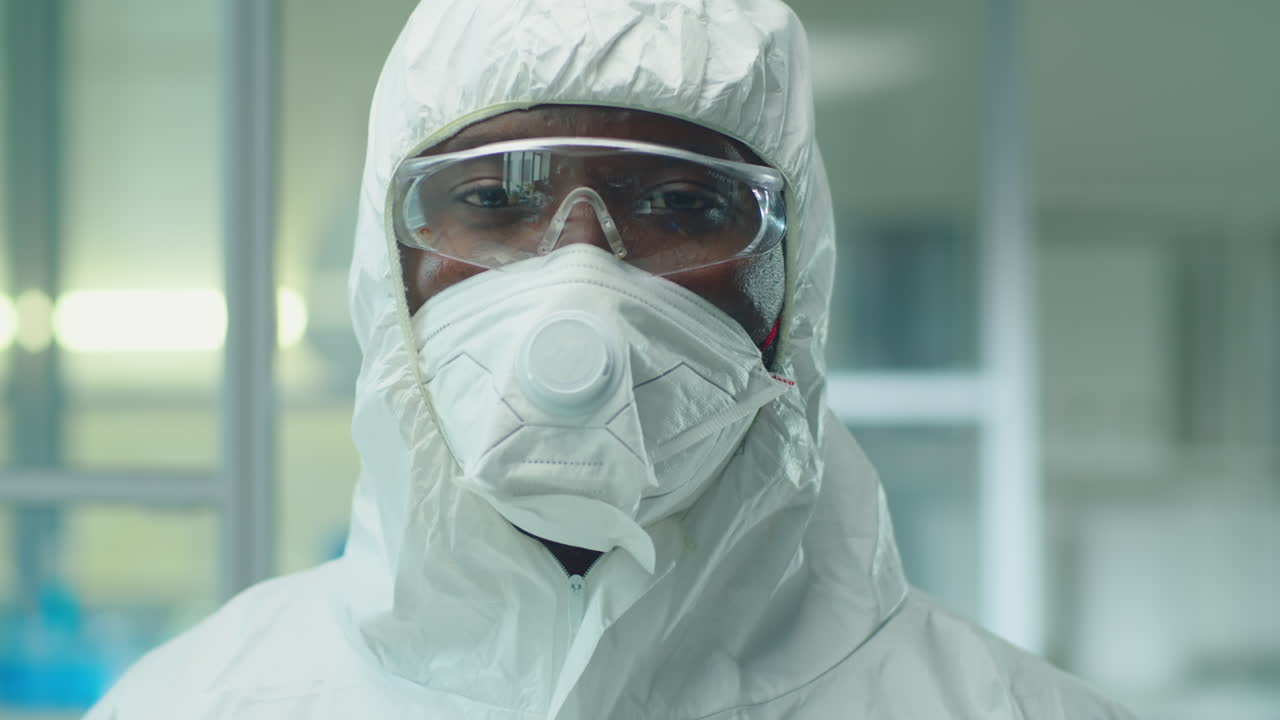 Portrait of African American Scientist in Protective Suit and Mask