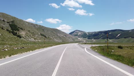 moving view (car, motorbike or bicycle) of a mountain landscape