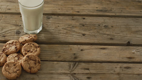 video of biscuits with chocolate and milk on wooden background