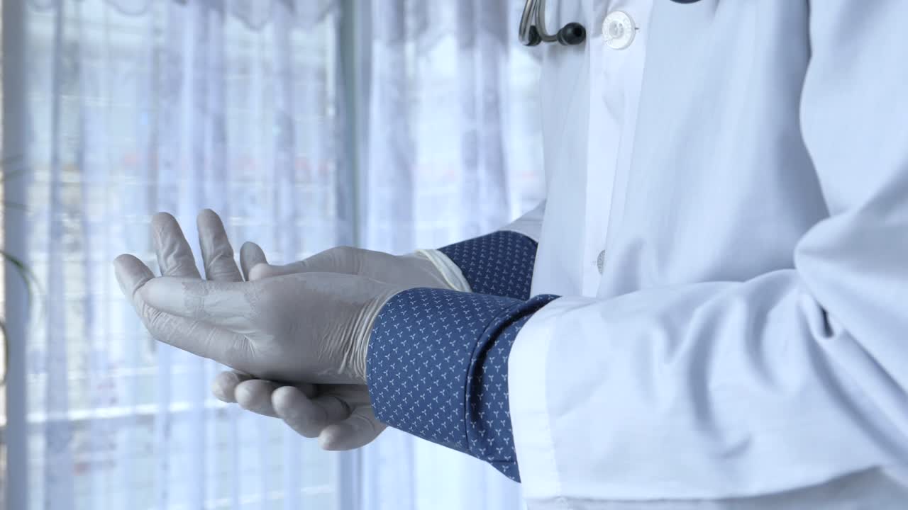 el doctor se pone los guantes.