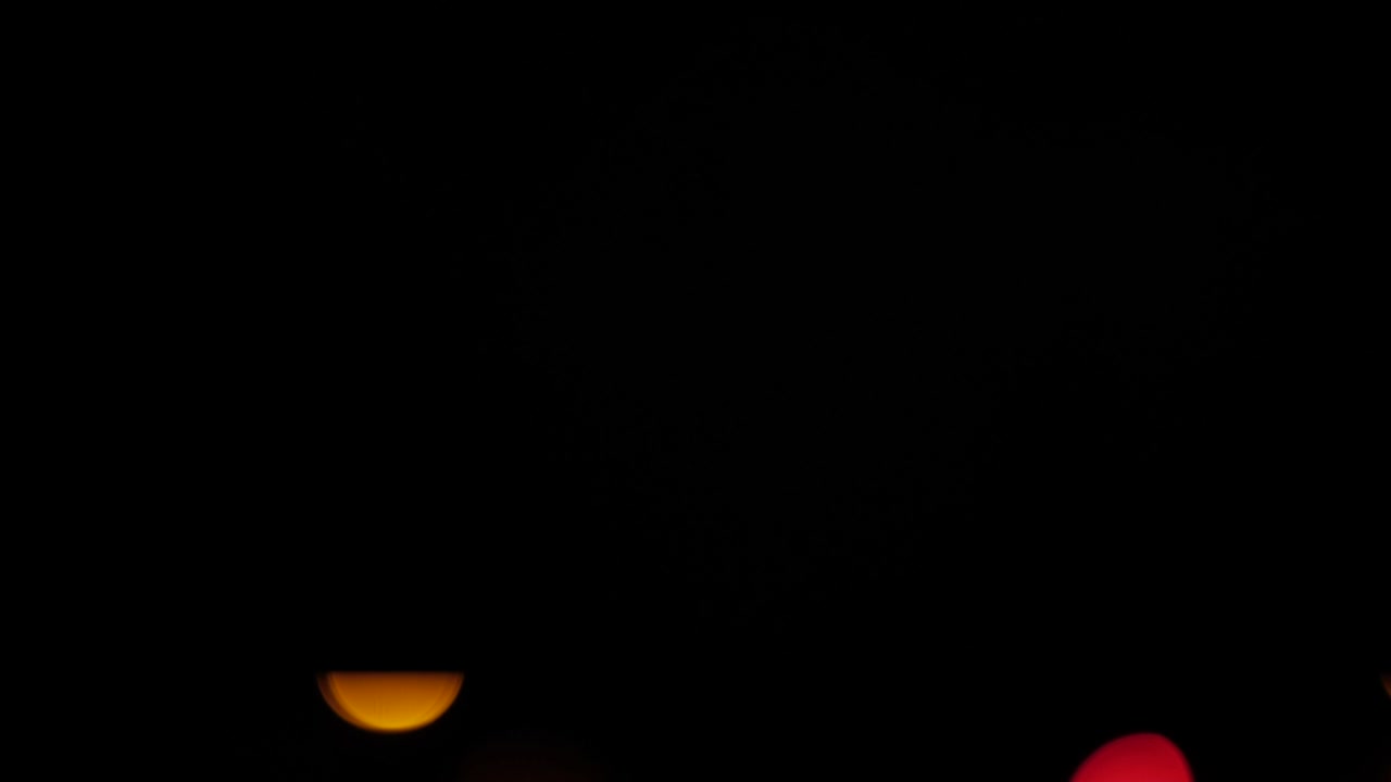 Blinking Christmas lights in background. Colourful bokeh