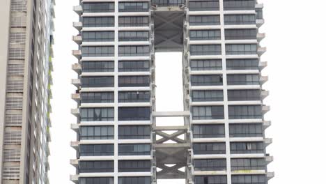 4k footage of a skyscraper office building consisting of two linked towers with some plants on the rooftop