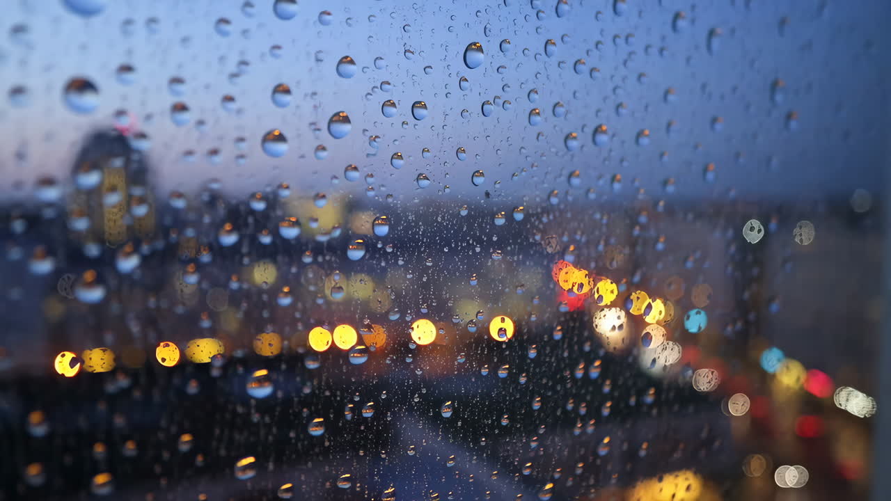 Raindrops on a Window with Bokeh City Lights at Night
