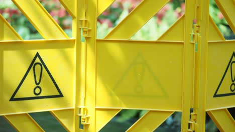 yellow plastic construction barrier with warning sign