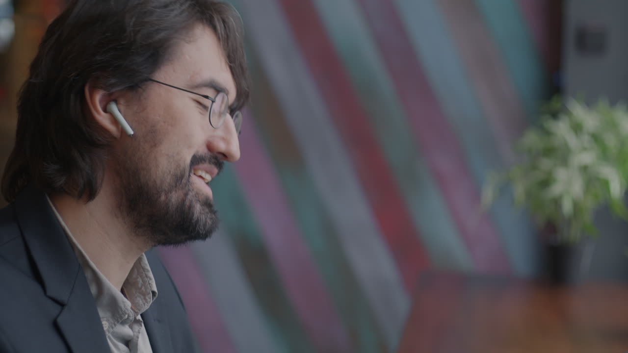 Man Listening intently in a Cafe