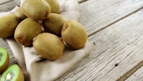 kiwi and knife on wooden plank