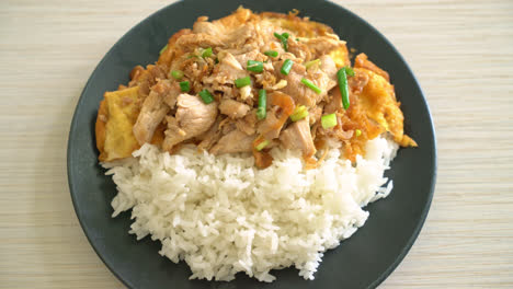 stir-fried pork with garlic and egg topped on rice - asian food style