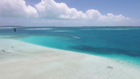 Drone-shot-KITESURF-IN-FLAT-tropical-SEA-WATER-,-coral-reef-LOS-ROQUES