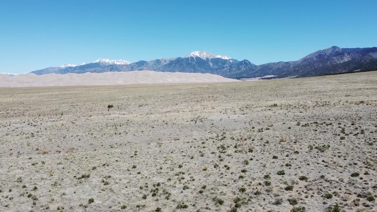 Drone view of sand dunes and mountains