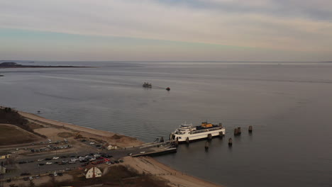 an aerial shot of an orient point ferry as it takes on vehicles and passengers