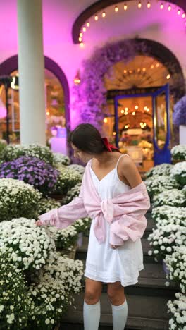 woman in a stylish outfit by a floral shop