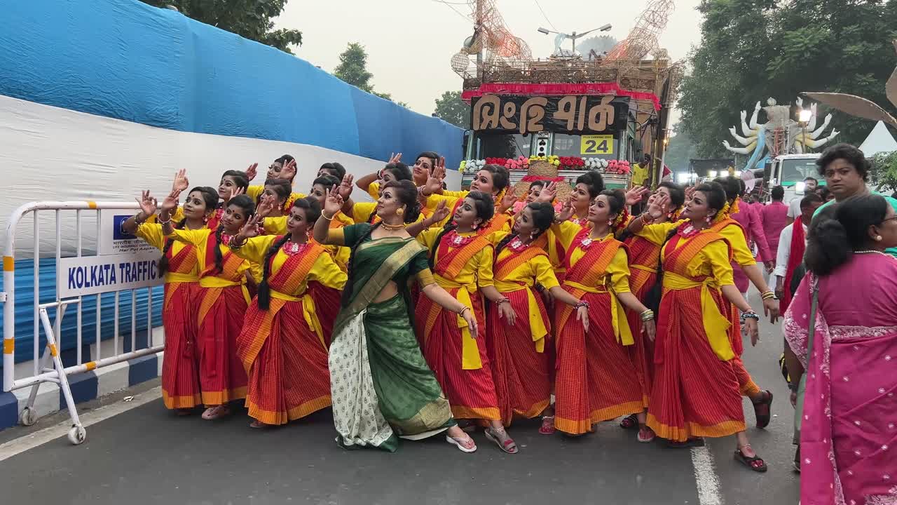 Dance group of Singhi Park club rehearsing the performance at Red Road before Durga puja procession in Kolkata, India.