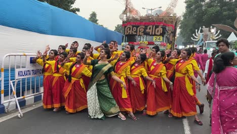 dance group of singhi park club rehearsing the performance at red road before durga puja procession in kolkata, india.