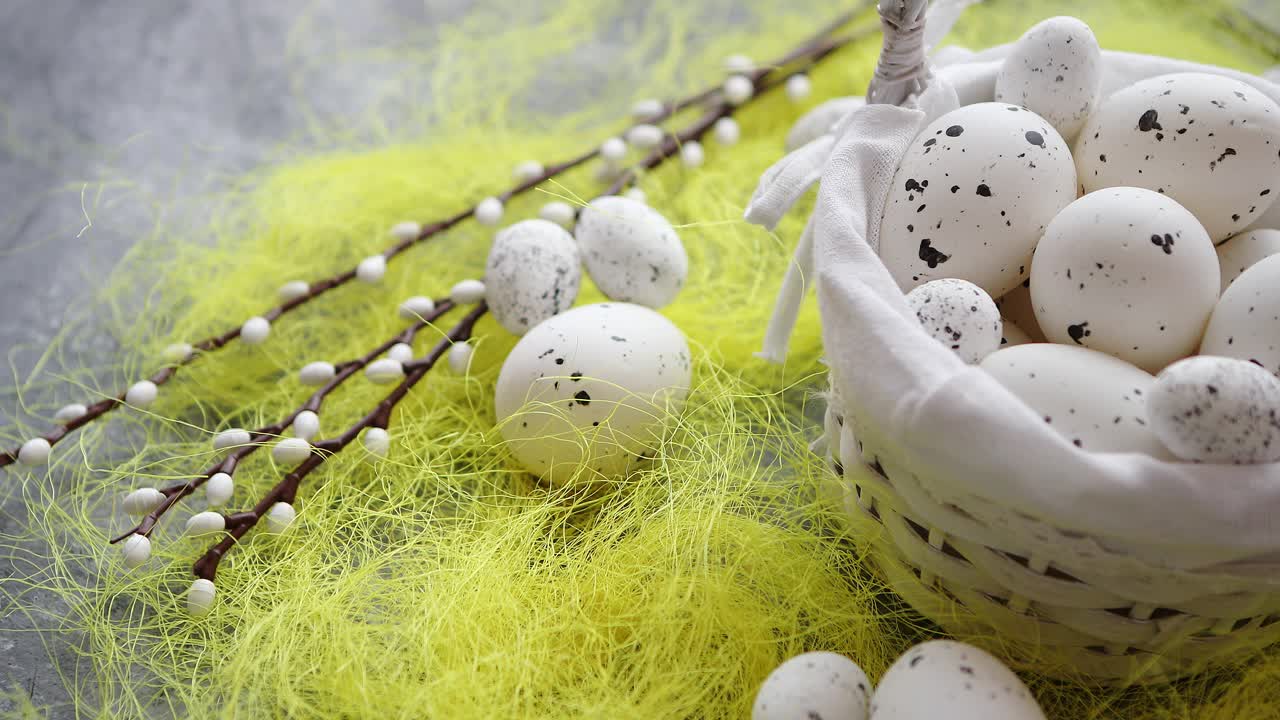 Easter white dotted Eggs in the nest and spring yellow grass