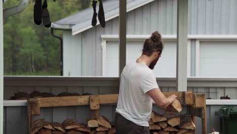 a man at the yard pile up log woods for fireplace