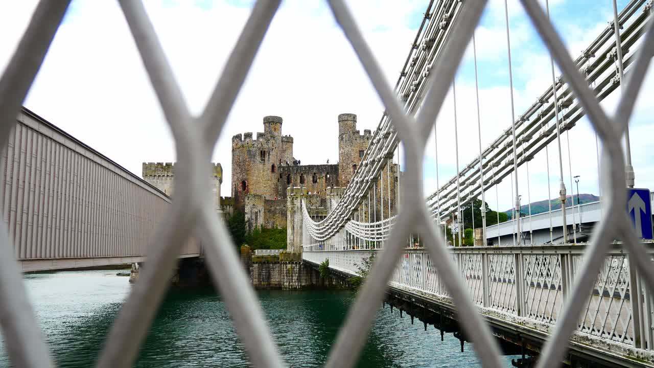 Conwy castle steel walkway landmark north Wales river suspension bridge slow dolly right