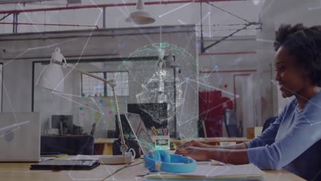 Animation-of-connected-dots-and-globe,-smiling-african-american-woman-working-in-laptop-in-office