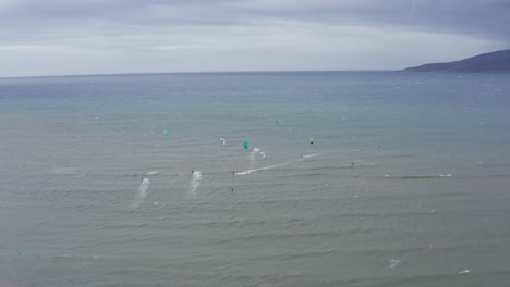 Amplia-Vista-Aérea-De-Windsurfistas-Surfeando-Las-Olas-De-La-Bahía-De-Maalaea-En-Maui,-Hawai