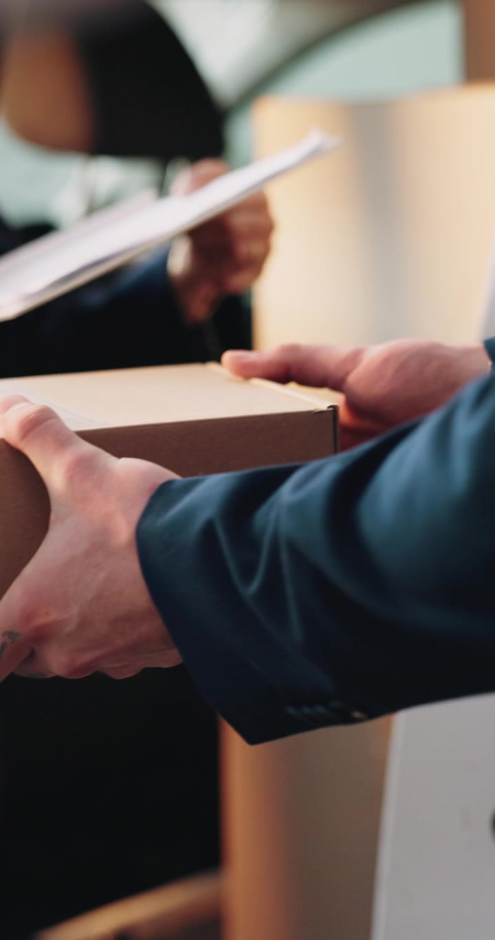 Delivery Person Handing Over Package and Receiving Signature