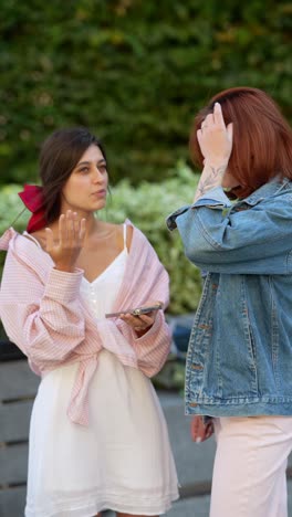 two women talking outdoors