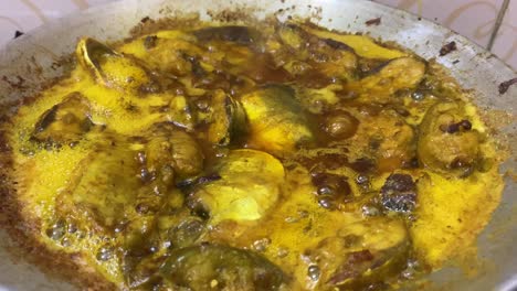 bengali hilsha fish simmering in sauce in pot