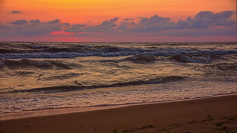 orange sunset timelapse seaside beach, with tide waves motion, scenic view