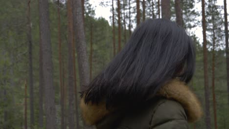 happy girl takes a walk in the forest