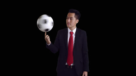 businessman spinning soccer ball, alpha channel, video in 4k