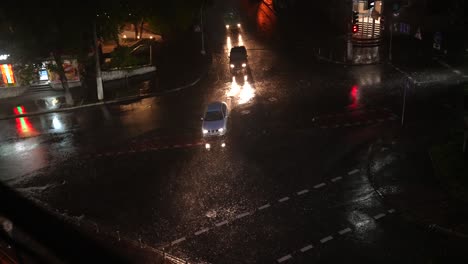 rainy night city street intersection with cars