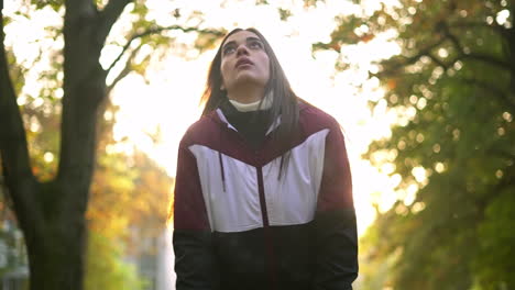 a woman in a park in autumn