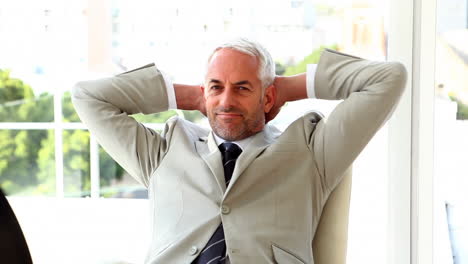 confident businessman relaxing on his chair