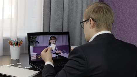 Man-teacher-making-video-call-on-laptop-with-little-pupil.-Distance-education