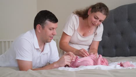 a loving couple joyfully engages in caring for their newborn baby a loving couple joyfully engages in caring for their newborn baby reflecting immense joy and tenderness as they bond