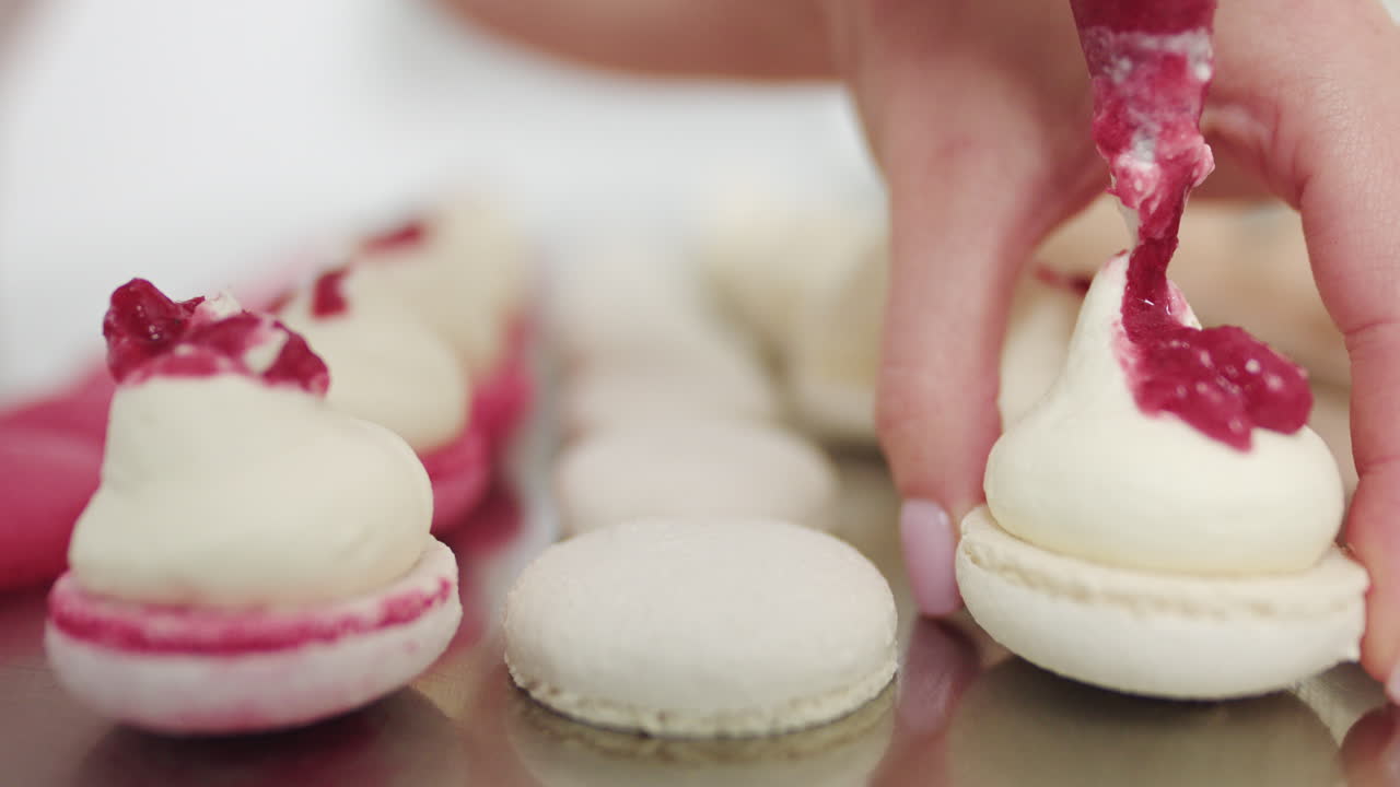 Close-up view of a pastry chef decorating macarons