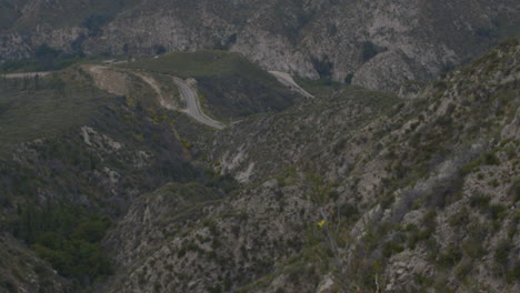 Ascending-shot-of-rocky-San-Gabriel-mountain-range-with-sparse-vegetation-located-at-Echo-Mountain-Trails-California