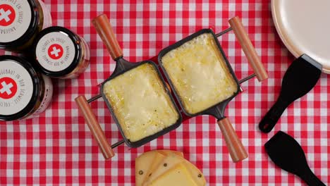 people eating raclette - swiss cheese speciality food