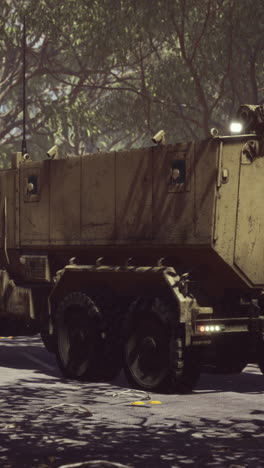 military cargo truck driving on a road