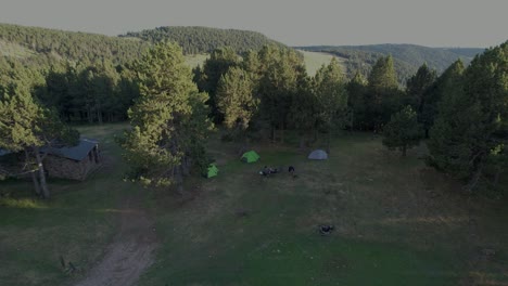 video flight with drone over camping on the top of a mountain with tents in a campsite