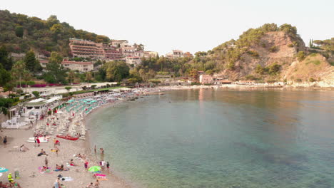 Bird's-eye-view-of-a-crowded-sandy-beach-by-the-clear-Mediterranean-Sea