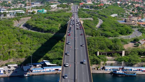 Queen-Juliana-Bridge,-Willemstad-Curacao-centered-bird's-eye-view-as-traffic-drives-both-ways