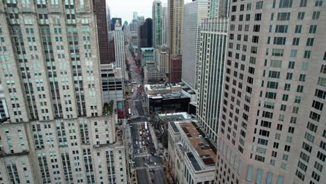 between skyscrapers in chicago, small tilt down and flying backwards aerial illinois usa 4k