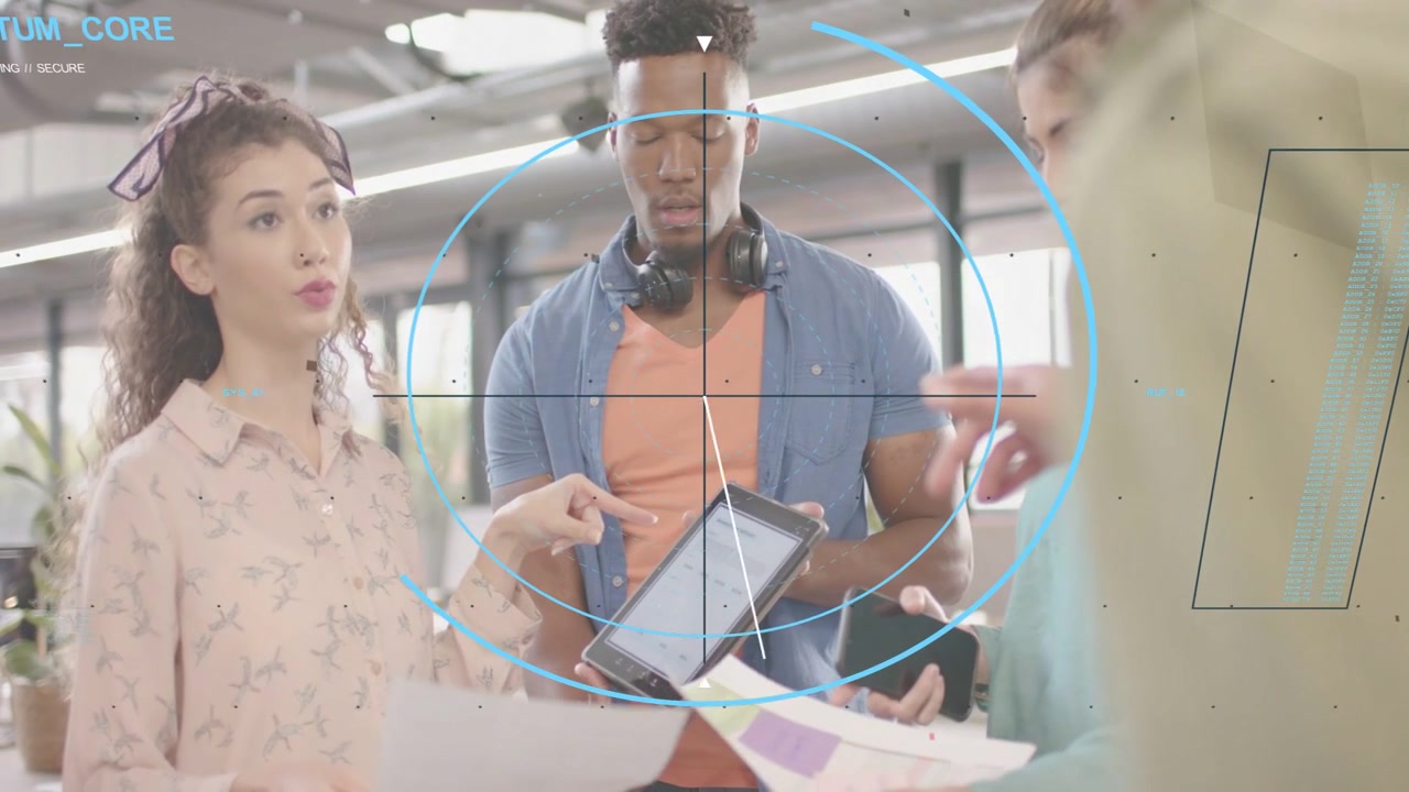 Left presenter pointing, team exchanging mockups and tapping tablet while HUD centering for review