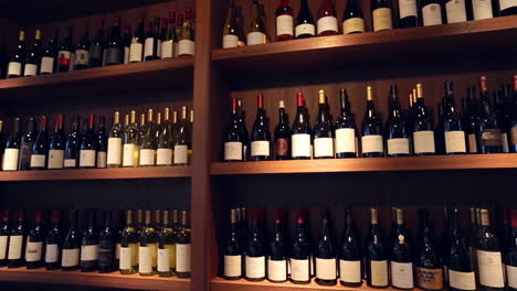 rows of wine bottles on wooden shelves