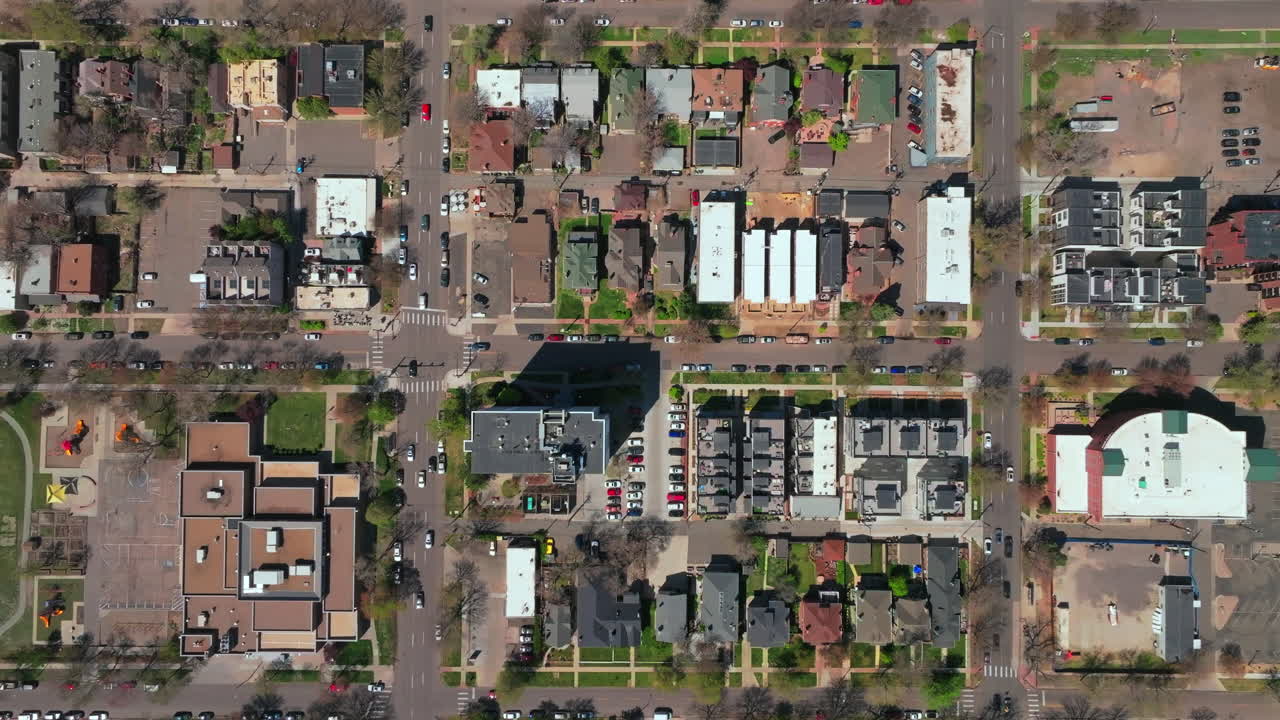 City Park downtown Denver Lodo Colorado aerial drone Birdseye view homes neighborhood buildings apartment cityscape landscape busy streets cars summer spring cars traffic upwards motion